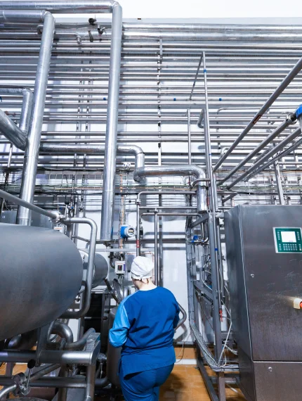 worker-production-department-make-set-up-line-while-standing-near-equipment-dairy-factory.jpg